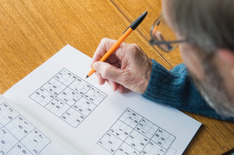 senior man playing sudoku